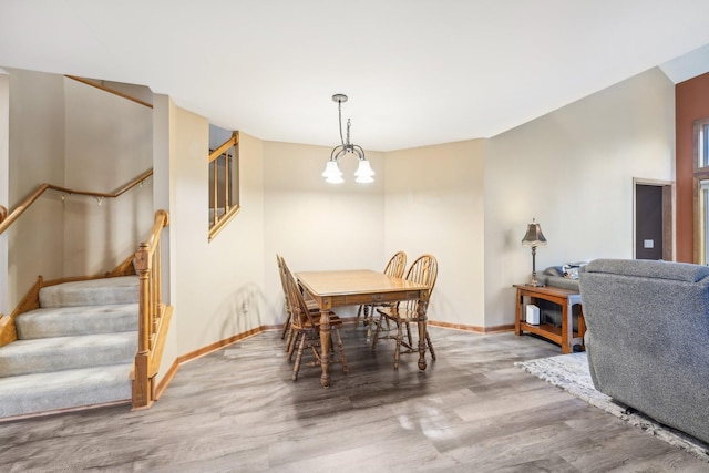 dining space with a notable chandelier and wood-type flooring