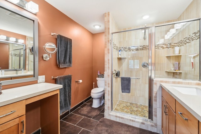 bathroom featuring vanity, tile patterned floors, toilet, and walk in shower