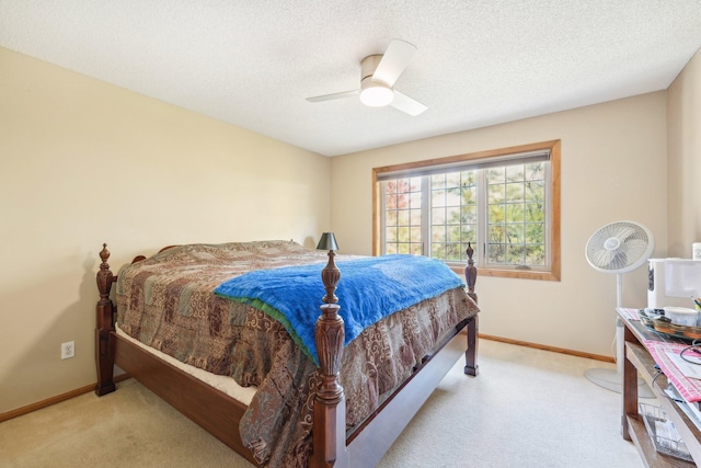 carpeted bedroom with ceiling fan and a textured ceiling