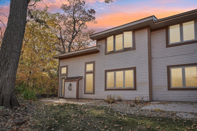 view of back house at dusk