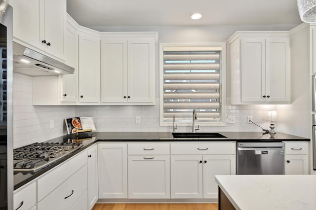 kitchen featuring white cabinets, light hardwood / wood-style floors, sink, and appliances with stainless steel finishes