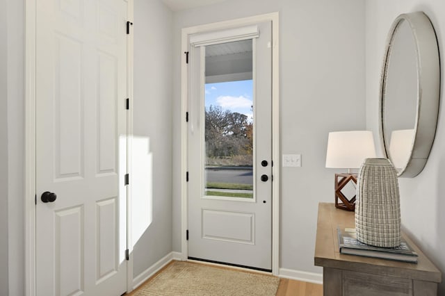 doorway to outside with light wood-type flooring