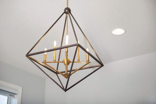 interior details featuring a textured ceiling and a notable chandelier