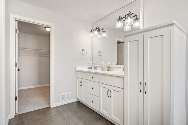 bathroom featuring tile patterned flooring and vanity