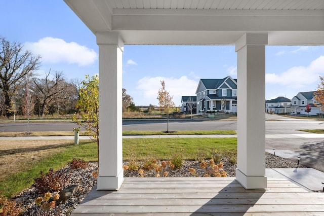 wooden terrace featuring a lawn