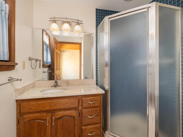 full bathroom featuring vanity and a stall shower