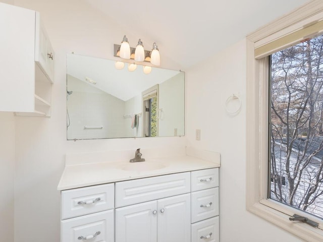 bathroom with vanity and vaulted ceiling