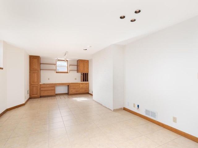 unfurnished living room with visible vents, baseboards, light tile patterned floors, recessed lighting, and built in study area