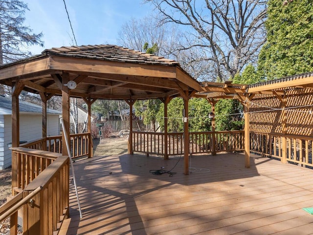 wooden terrace featuring a gazebo, a pergola, and fence