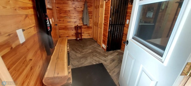 interior space featuring parquet floors and wooden walls