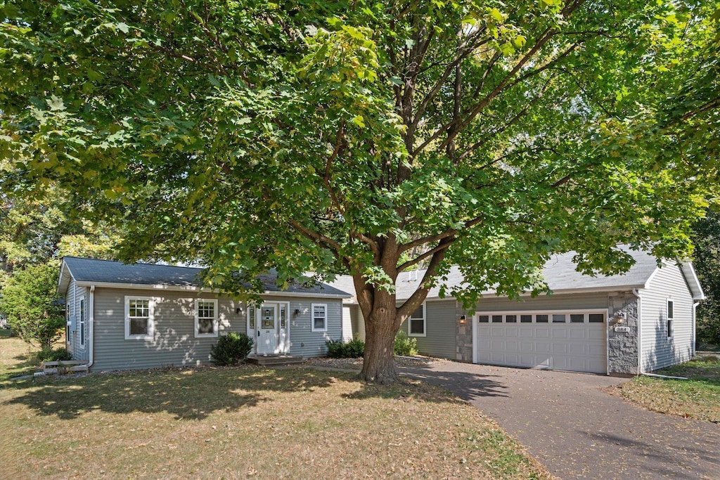 view of front facade with a garage and a front lawn