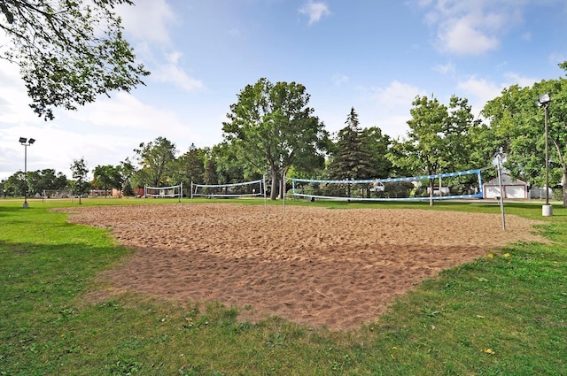 view of community with a yard and volleyball court