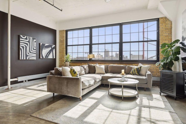 living room with concrete floors and brick wall