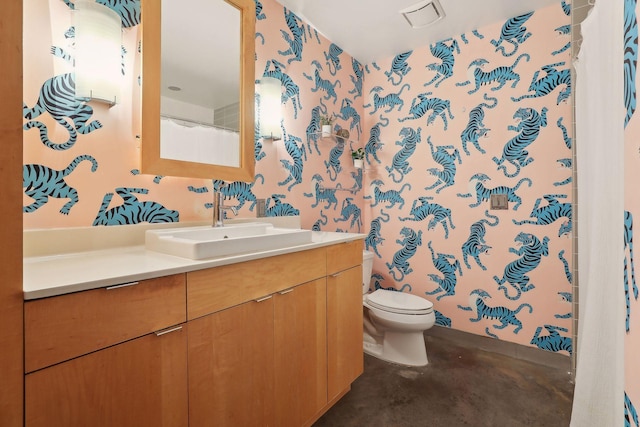 bathroom featuring vanity and toilet