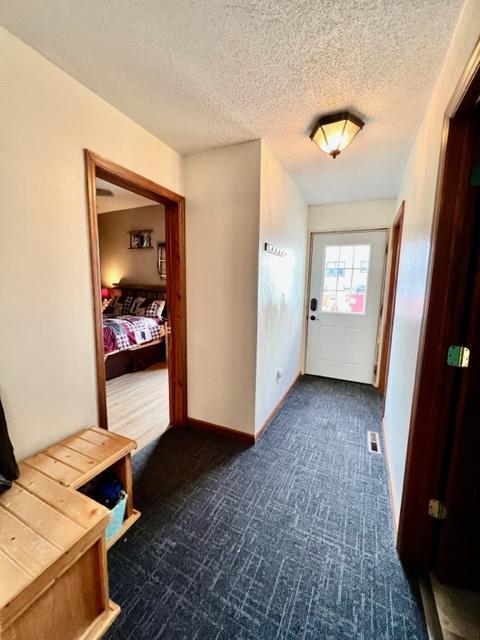 hall with a textured ceiling