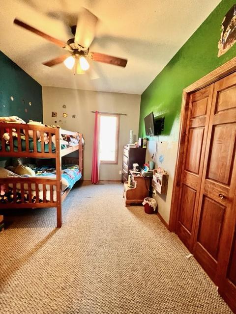 bedroom featuring ceiling fan and light colored carpet