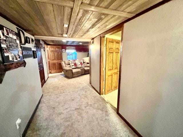 hall featuring wood ceiling and light colored carpet