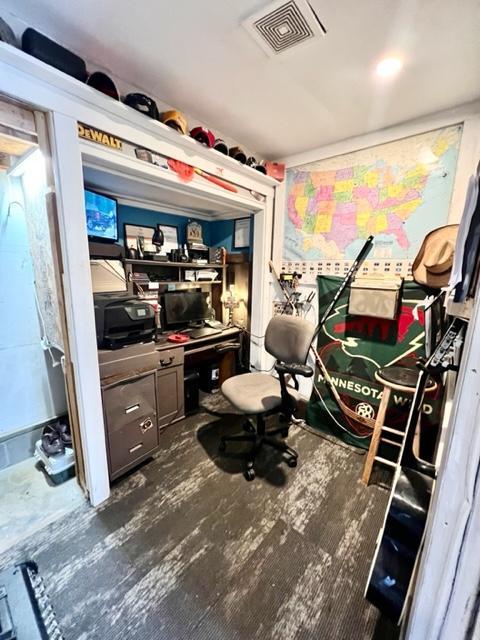 interior space featuring built in desk and dark wood-type flooring