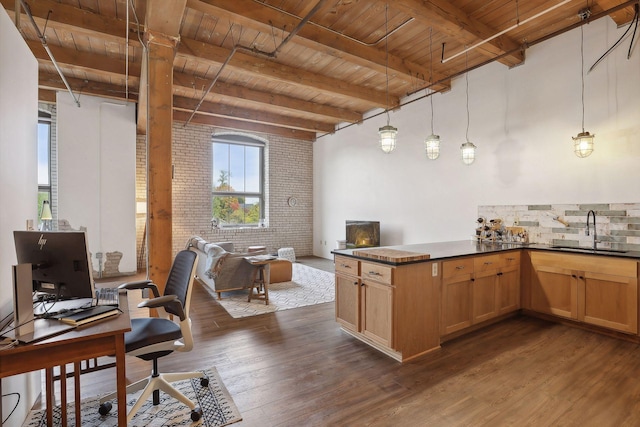 kitchen featuring sink, dark wood-type flooring, wooden ceiling, brick wall, and decorative light fixtures