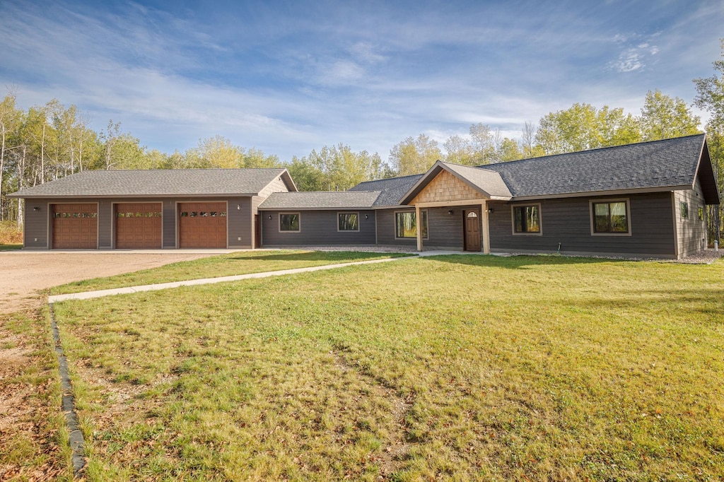 ranch-style house with a front yard and a garage