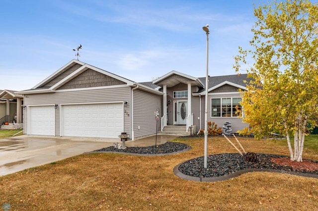 view of front of house with a front yard and a garage