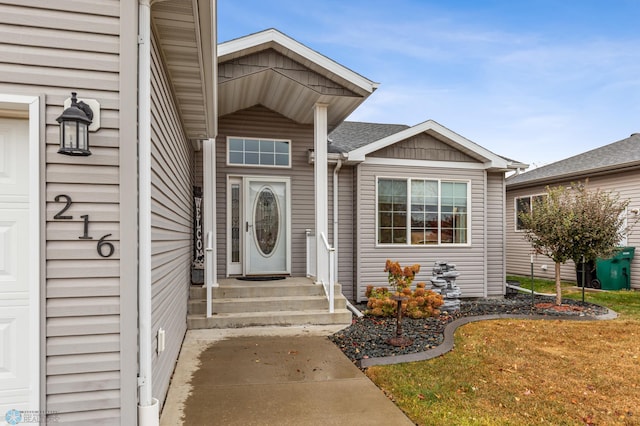 doorway to property featuring a lawn