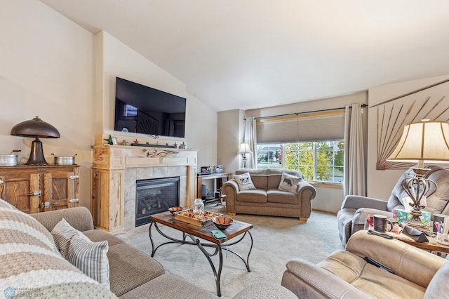 carpeted living room featuring a tiled fireplace and vaulted ceiling