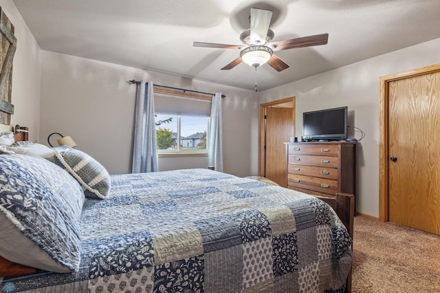 bedroom featuring ceiling fan and light carpet