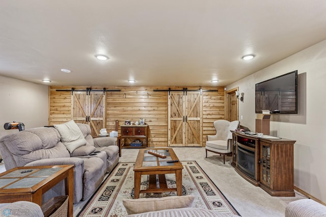 carpeted living room featuring a barn door