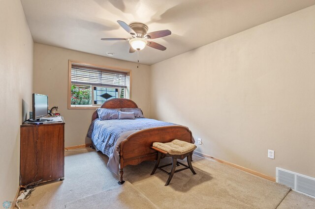 bedroom with light carpet and ceiling fan