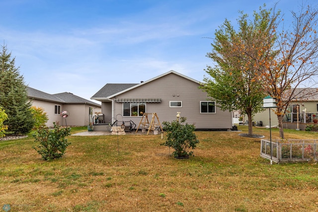 back of house with a yard and a patio area