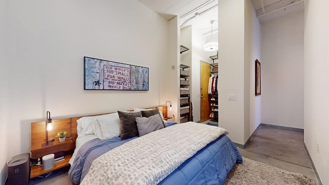 bedroom featuring concrete floors and a closet