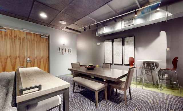 dining area with rail lighting, visible vents, and baseboards