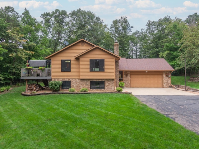 split level home with a garage, a deck, and a front lawn