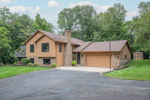 view of front of property with a storage unit, a garage, and a front lawn