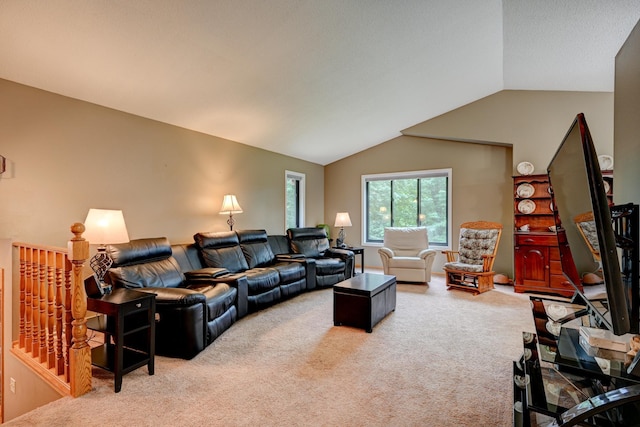 carpeted living room with vaulted ceiling