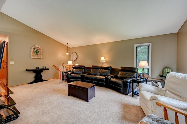 carpeted living room featuring vaulted ceiling