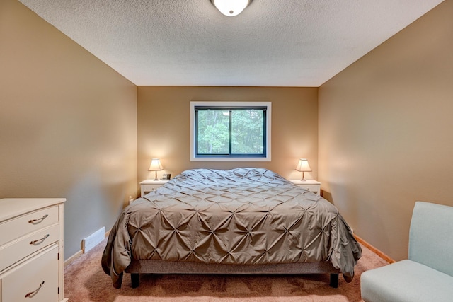 carpeted bedroom with a textured ceiling