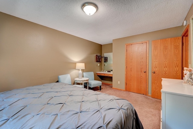 bedroom with carpet flooring and a textured ceiling