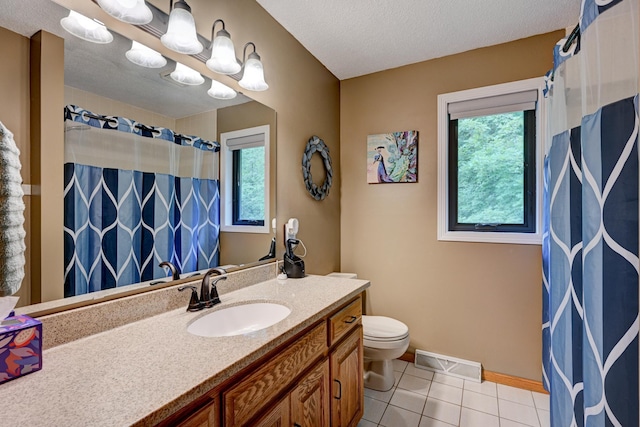 bathroom featuring toilet, plenty of natural light, a textured ceiling, and tile patterned flooring