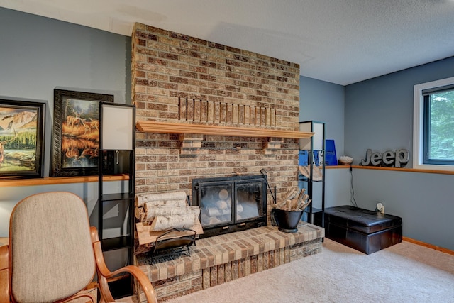 living room featuring carpet, a fireplace, and a textured ceiling