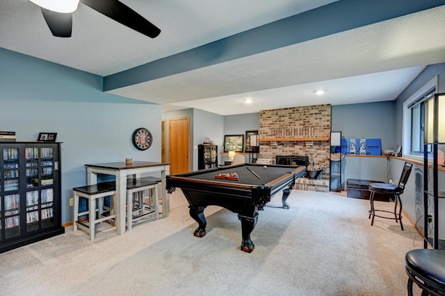 recreation room with a textured ceiling, light colored carpet, ceiling fan, and pool table