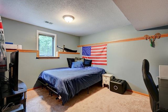 bedroom featuring carpet flooring and a textured ceiling