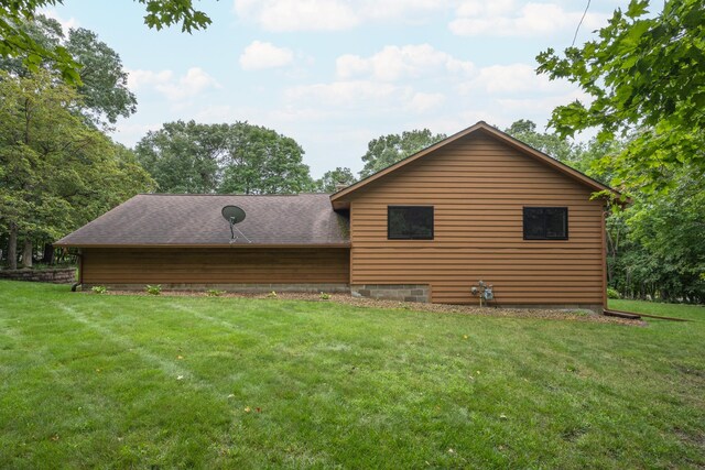 rear view of house featuring a yard