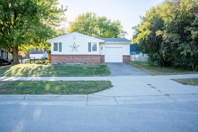 view of front facade featuring a front yard and a garage