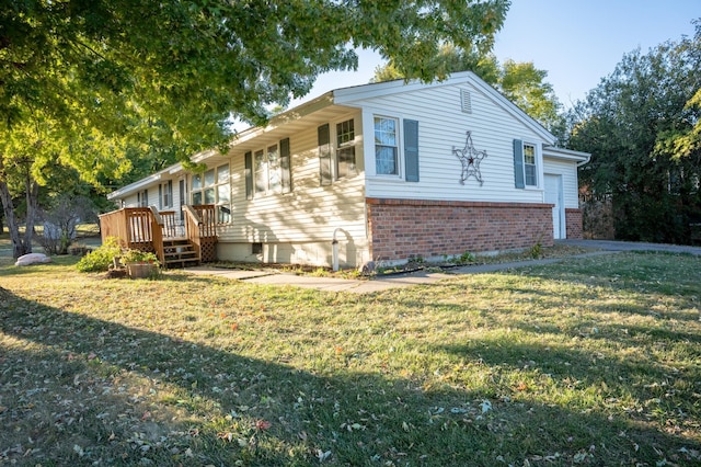 view of home's exterior with a deck and a lawn