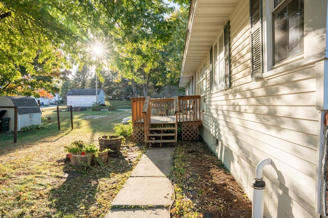 view of yard with a deck and a storage unit