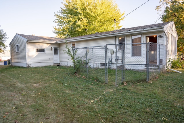 rear view of property featuring a yard