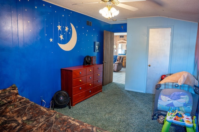 carpeted bedroom featuring lofted ceiling, ceiling fan, and a textured ceiling