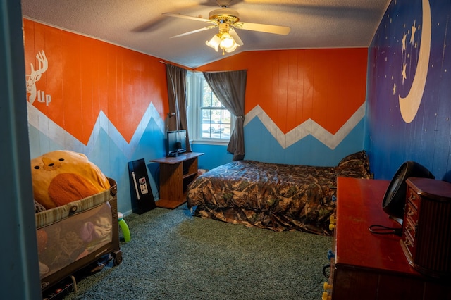 carpeted bedroom featuring lofted ceiling, wooden walls, ceiling fan, and a textured ceiling